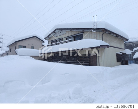 寒波襲来大雪に覆われた雪国の家 135680701