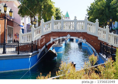 Streets and canals of old Venice in Thailand with wooden gondolas, stone bridges, and a  sky in the background.Little Venice in Thailand. 135681049