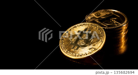 Bitcoin Cryptocurrency. Gold coins on black background. Bitcoin Cryptocurrency. Gold coins on black background. 135682694