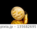 Litecoin cryptocurrency. Gold coins on black background. 135682695