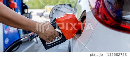 Man Refill and filling Oil Gas Fuel at station. Gas station - refueling. Man Refill and filling Oil Gas Fuel at station. Gas station - refueling. 135682728