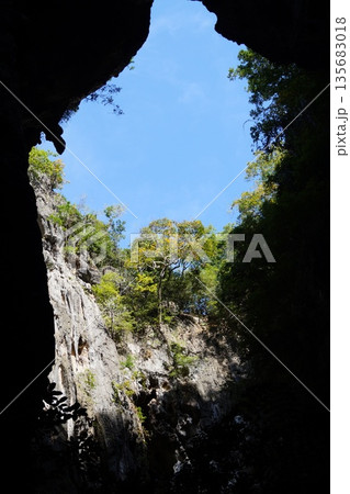 Blue sky and green plants visible from the cave.View of the sky from the cave. Blue sky and green plants visible from the cave.View of the sky from the cave. 135683018
