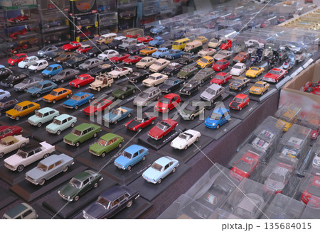 Flea antique market in Europe, Italy. Old vintage items. Toys, car, transport on tables in town. Retro objects for background design. Flea antique market in Europe, Italy. Old vintage items. Toys, car, transport on tables in town. Retro objects for background design. 135684015