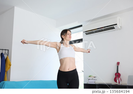 Embracing positivity in a bright living space during the morning stretch Embracing positivity in a bright living space during the morning stretch 135684194