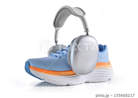 Running shoe with modern wireless headphones for fitness music 135688217