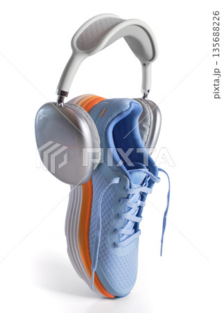Sneaker and headphones representing fitness, music, and active lifestyle 135688226