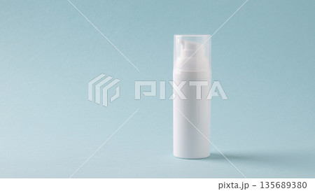 White cosmetic bottle on blue background White cosmetic bottle on blue background 135689380