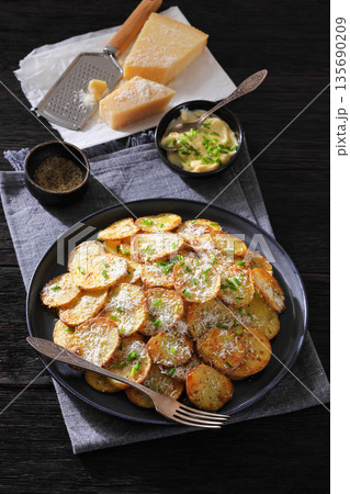 Roasted Potato Slices with Parmesan Cheese Top View Roasted Potato Slices with Parmesan Cheese Top View 135690209
