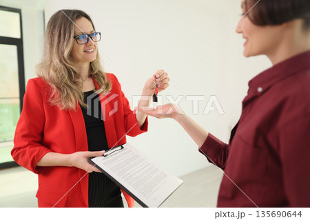 New beginning as keys are handed over in a bright room showcasing excitement and hope 135690644