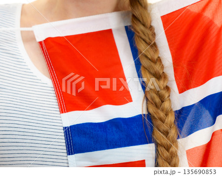 Young woman holding norwegian flag Young woman holding norwegian flag 135690853