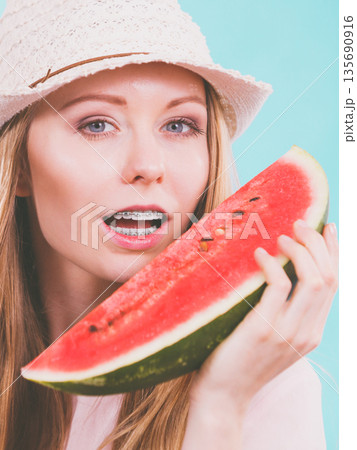 Happy woman holding watermelon Happy woman holding watermelon 135690916