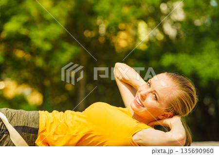Girl relaxing after exercise gym outdoor Girl relaxing after exercise gym outdoor 135690960