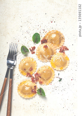 fresh ravioli, with butter, spices and herbs, fried bacon, on the table, top view, light background, no people, fresh ravioli, with butter, spices and herbs, fried bacon, on the table, top view, light background, no people, 135691182