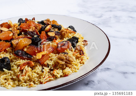 rice dish with dried fruits, nuts and spices of Middle Eastern cuisine, homemade, no people, 135691183