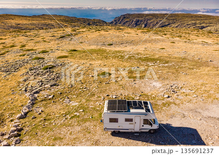 Caravan solar panels on roof camp in mountains. Aerial view 135691237