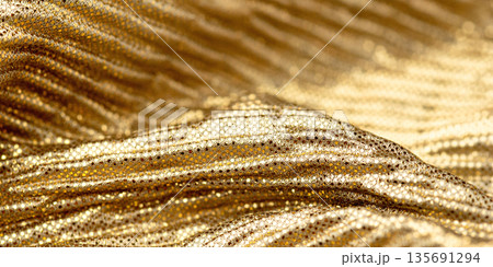 A close-up shot of gold sequin fabric 135691294