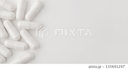 White pills on a white background 135691297