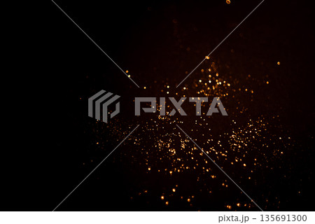 Golden abstract bokeh on black background. Golden abstract bokeh on black background. 135691300