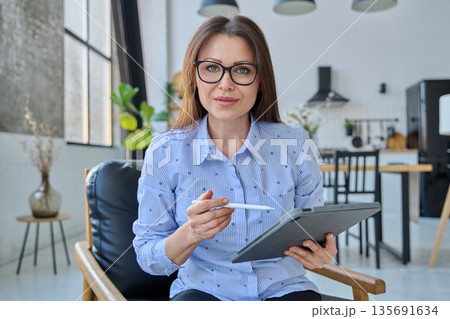 Webcam view woman entrepreneur, teacher working online remotely in home office 135691634