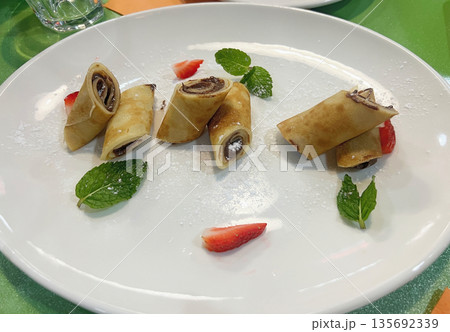 Pancakes with chocolate spread and strawberries Pancakes with chocolate spread and strawberries 135692339