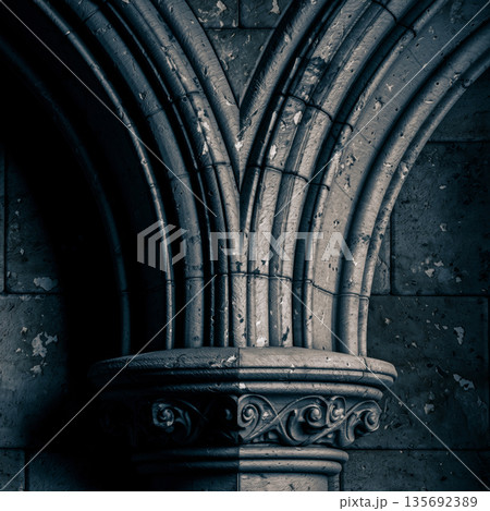 Gothic stone arch detail with medieval architectural ornament and strong structural geometry 135692389
