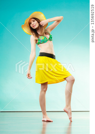 Woman in straw summer hat and bikini 135692519