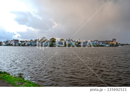 Old houses in Dutch water village of Zaanse Schans building architecture Netherlands. Waterfront landscape Old houses in Dutch water village of Zaanse Schans building architecture Netherlands. Waterfront landscape 135692521