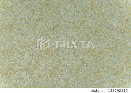 Golden leopard pattern on light olive green textile background Golden leopard pattern on light olive green textile background 135692816