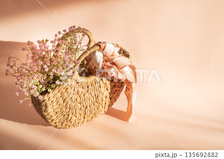 Straw Handbag and Flowers. Elegant Spring Summer Fashion Still Life on Pink Background 135692882