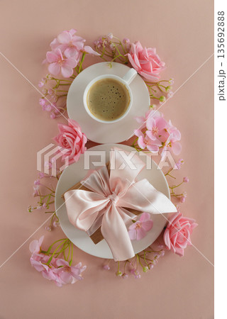 Coffee Cups, Gift Box and Pink Flowers in Shape of Eight. Elegant Flatlay for International Womens Day 135692888