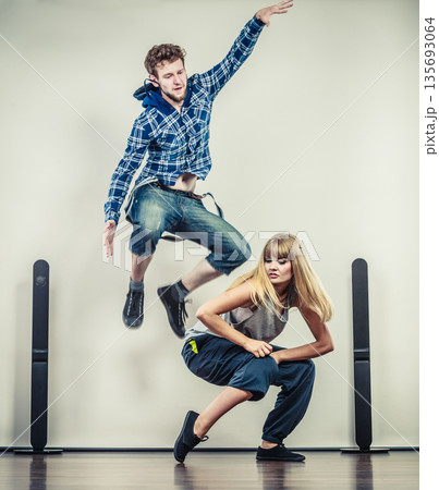 couple of young man and woman dancing hip-hop 135693064