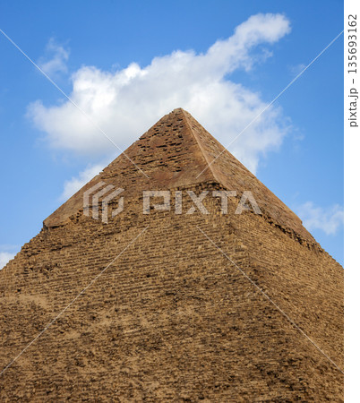 Top of the Great Pyramid of Giza against blue sky and white clouds. Top of the Great Pyramid of Giza against blue sky and white clouds. 135693162