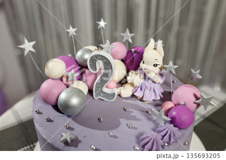 Cute birthday cake with number 2 and bunny decoration Cute birthday cake with number 2 and bunny decoration 135693205