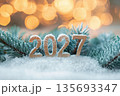 The glden letters 2027 with christmas trees spruce branches and snow. 135693347