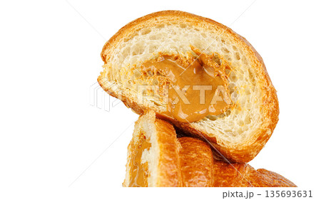 Sliced croissant with caramel condensed milk filling isolated on white. Tasty sweet French pastry. Sliced croissant with caramel condensed milk filling isolated on white. Tasty sweet French pastry. 135693631