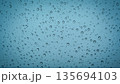 Water droplets on glass surface with soft blue background 135694103