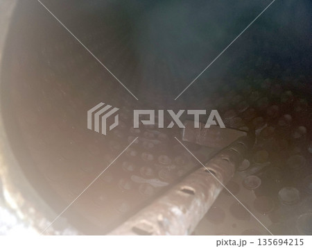 Steam Boiler Drum With Tool Inside During Maintenance Process Observed From the Interior View 135694215