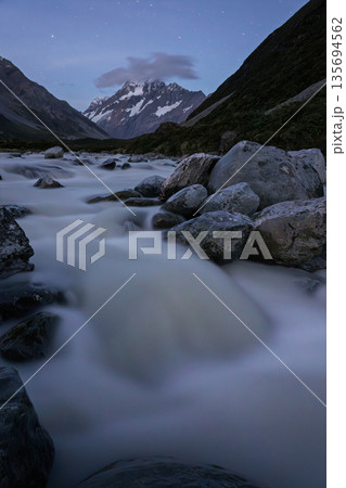Long exposure of Hooker River flowing under Mount Cook at night, New Zealand 135694562