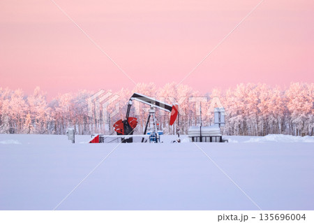 Snow Covered Oil Pumpjack at Winter Sunrise Snow Covered Oil Pumpjack at Winter Sunrise 135696004
