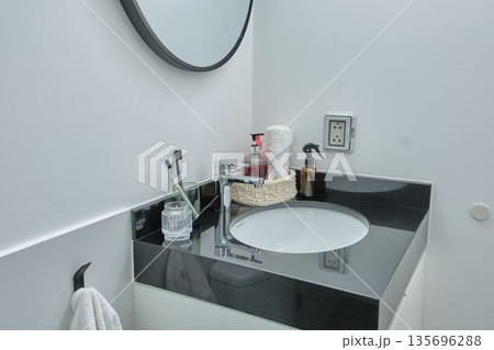 Modern bathroom vanity with sink and toiletries Modern bathroom vanity with sink and toiletries 135696288