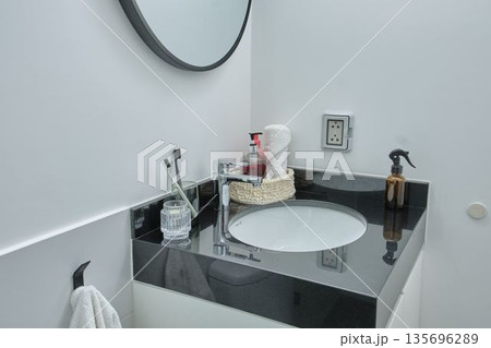 Modern bathroom interior with black granite sink countertop 135696289