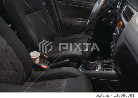 Car interior with coffee cup on center console Car interior with coffee cup on center console 135696391