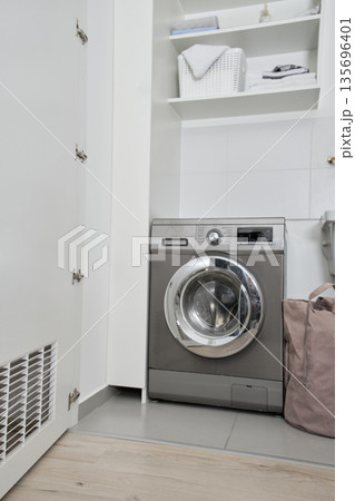 Washing machine in domestic laundry room producing clean clothes 135696401