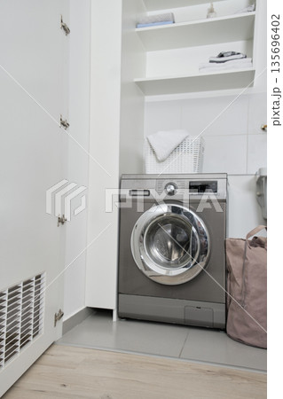 Modern washing machine in minimalist laundry room interior Modern washing machine in minimalist laundry room interior 135696402