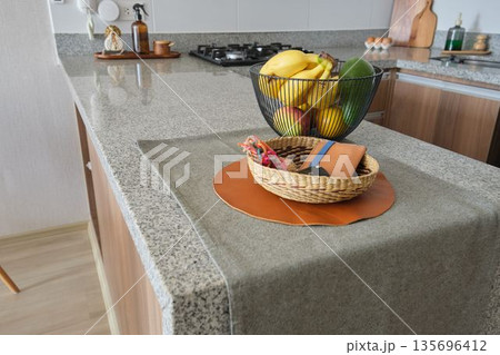 Kitchen island with fruit basket and decorative items Kitchen island with fruit basket and decorative items 135696412