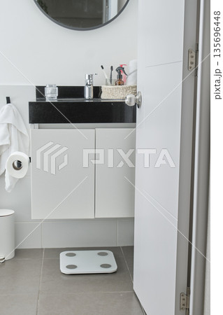Modern bathroom interior with vanity, sink, and weight scale Modern bathroom interior with vanity, sink, and weight scale 135696448