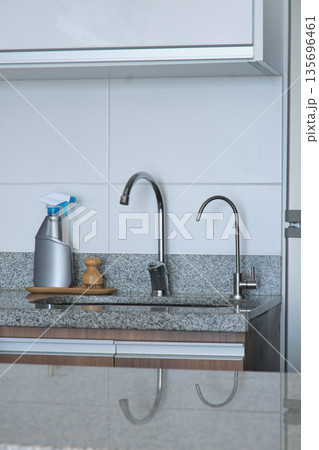 Modern kitchen countertop with sink and cleaning supplies Modern kitchen countertop with sink and cleaning supplies 135696461