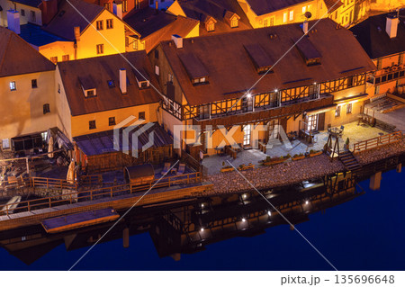 Evening lights reflecting on riverside houses 135696648