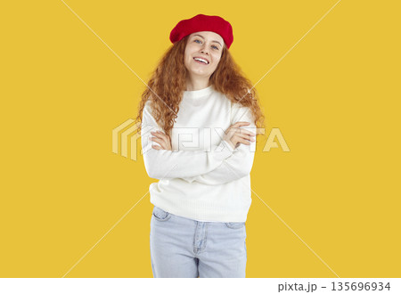 Cheerful, cute and stylish young woman posing smiling on orange background in studio. Cheerful, cute and stylish young woman posing smiling on orange background in studio. 135696934