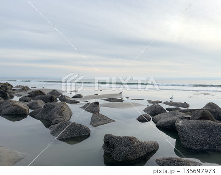 Stunning view at beach with coastal rocks and clear ocean water 135697973